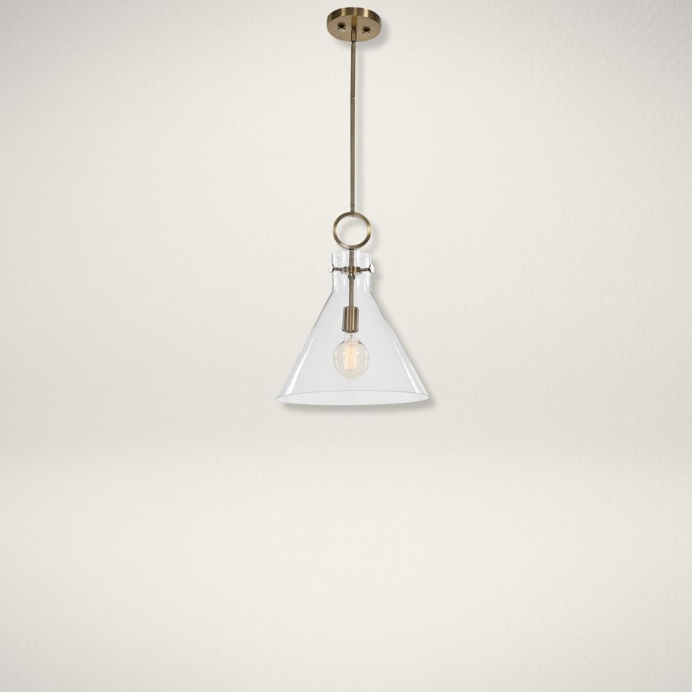 Uttermost Imbuto Sconce Modern sconce with a clear glass cone shade, antique brass accents, and an exposed bulb design.