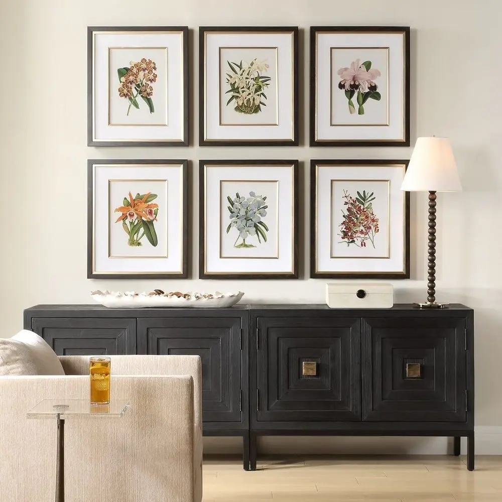 Set of six framed botanical orchid prints in soft, natural colors with dark wood frames and white mats.