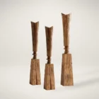 Tall handcrafted wooden sculpture with natural grain and geometric carved detailing.