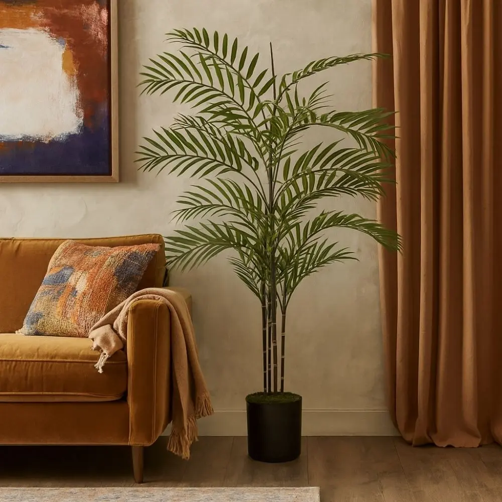 Artificial palm plant with tall green fronds in a black pot.