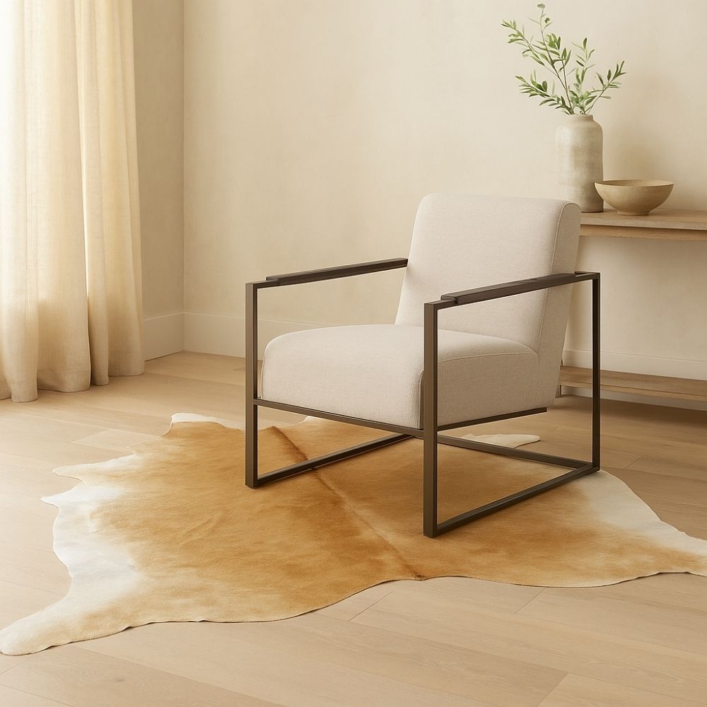 Natural beige cowhide rug with soft neutral tones and an organic freeform shape.