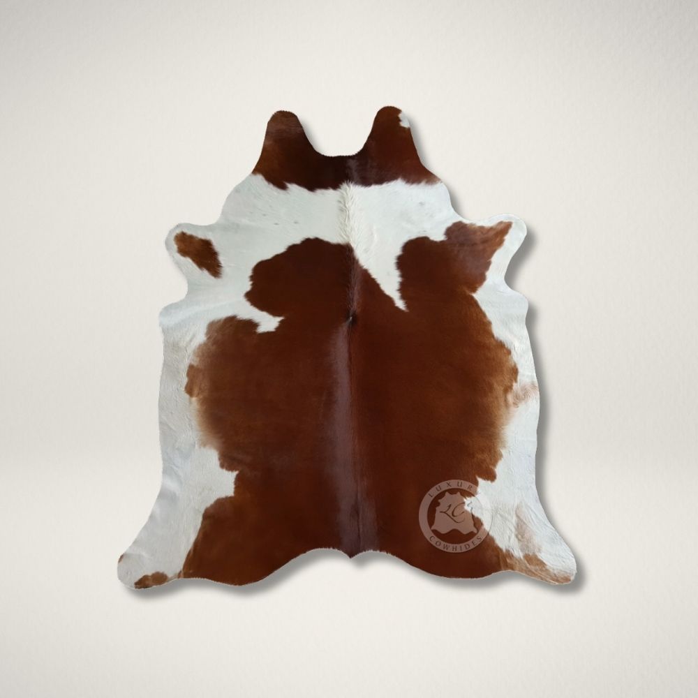 LC BROWN AND WHITE COWHIDE Natural brown and white cowhide rug with soft, organic shape and smooth finish.