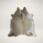 Natural champagne cowhide rug with soft neutral sheen and organic shape.