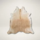 Natural light beige cowhide rug with smooth texture and soft tonal variations.