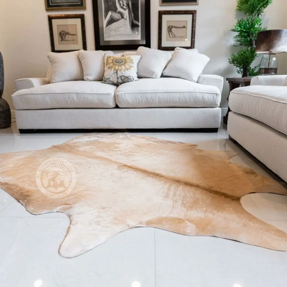 Natural light beige cowhide rug with smooth texture and soft tonal variations.