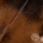 Natural mahogany brown cowhide rug featuring rich tones and a soft, organic silhouette.