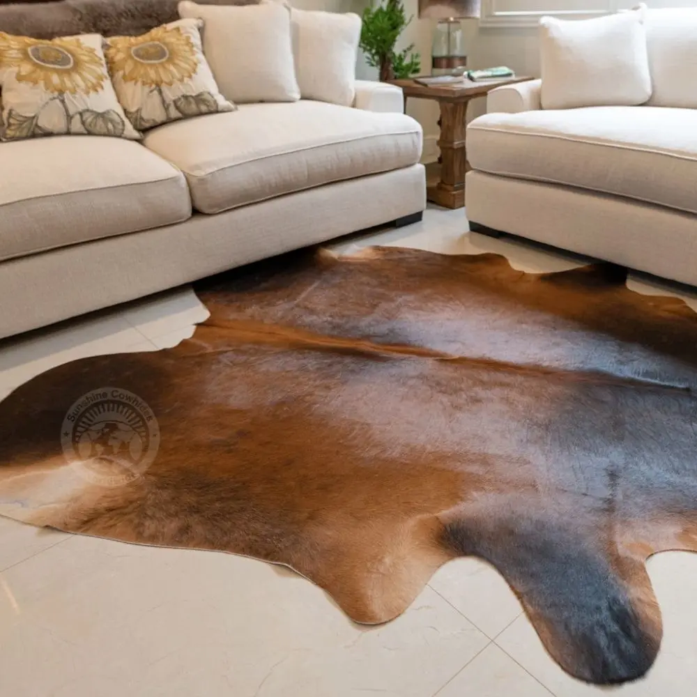 Natural mahogany brown cowhide rug featuring rich tones and a soft, organic silhouette.