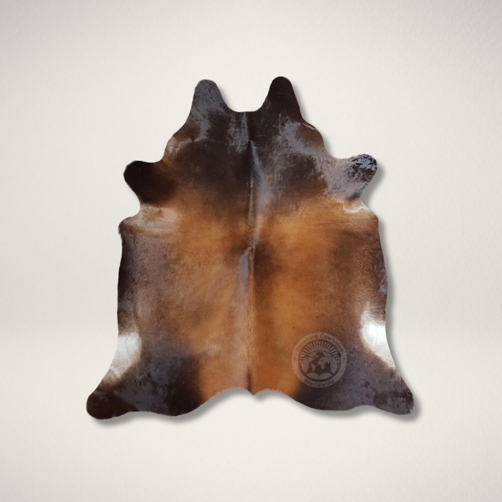 LC MAHOGANEY COWHIDE Natural mahogany brown cowhide rug featuring rich tones and a soft, organic silhouette.