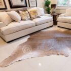 Natural taupe cowhide rug with unique organic shape and soft neutral tones.