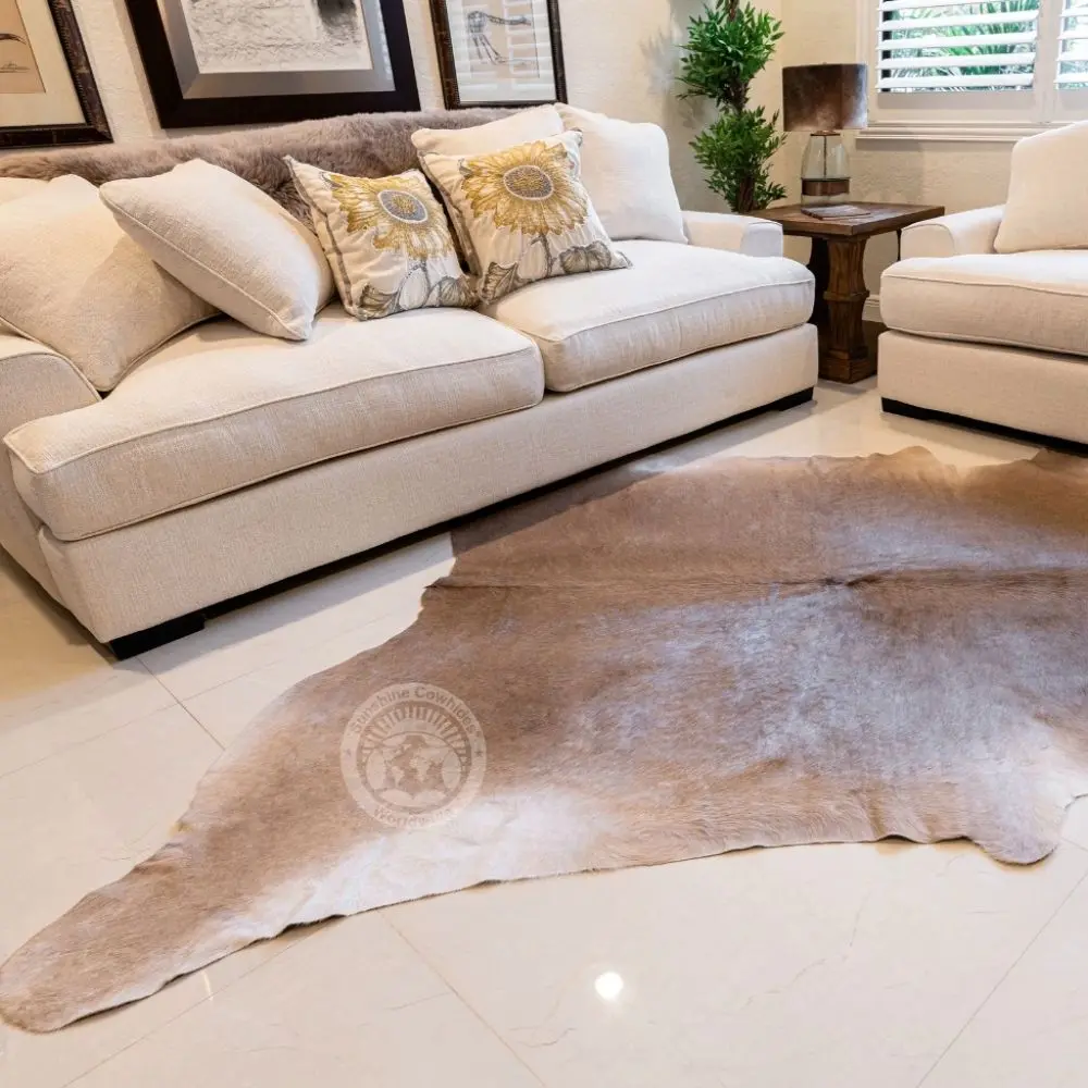 Natural taupe cowhide rug with unique organic shape and soft neutral tones.