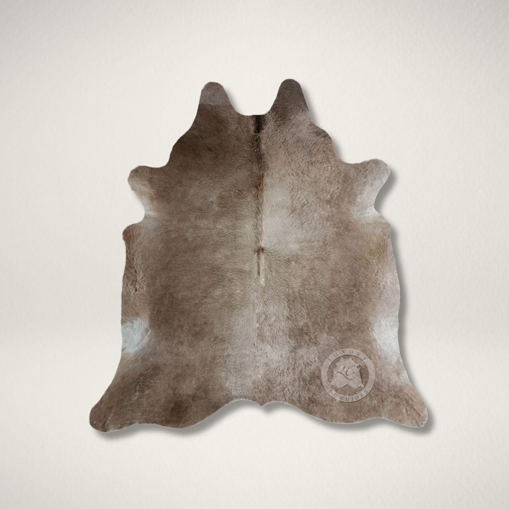 LC TAUPE COWHIDE Natural taupe cowhide rug with unique organic shape and soft neutral tones.