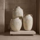 Set of three large handcrafted vases with a distressed, textured white finish and classic Mediterranean-inspired shapes.