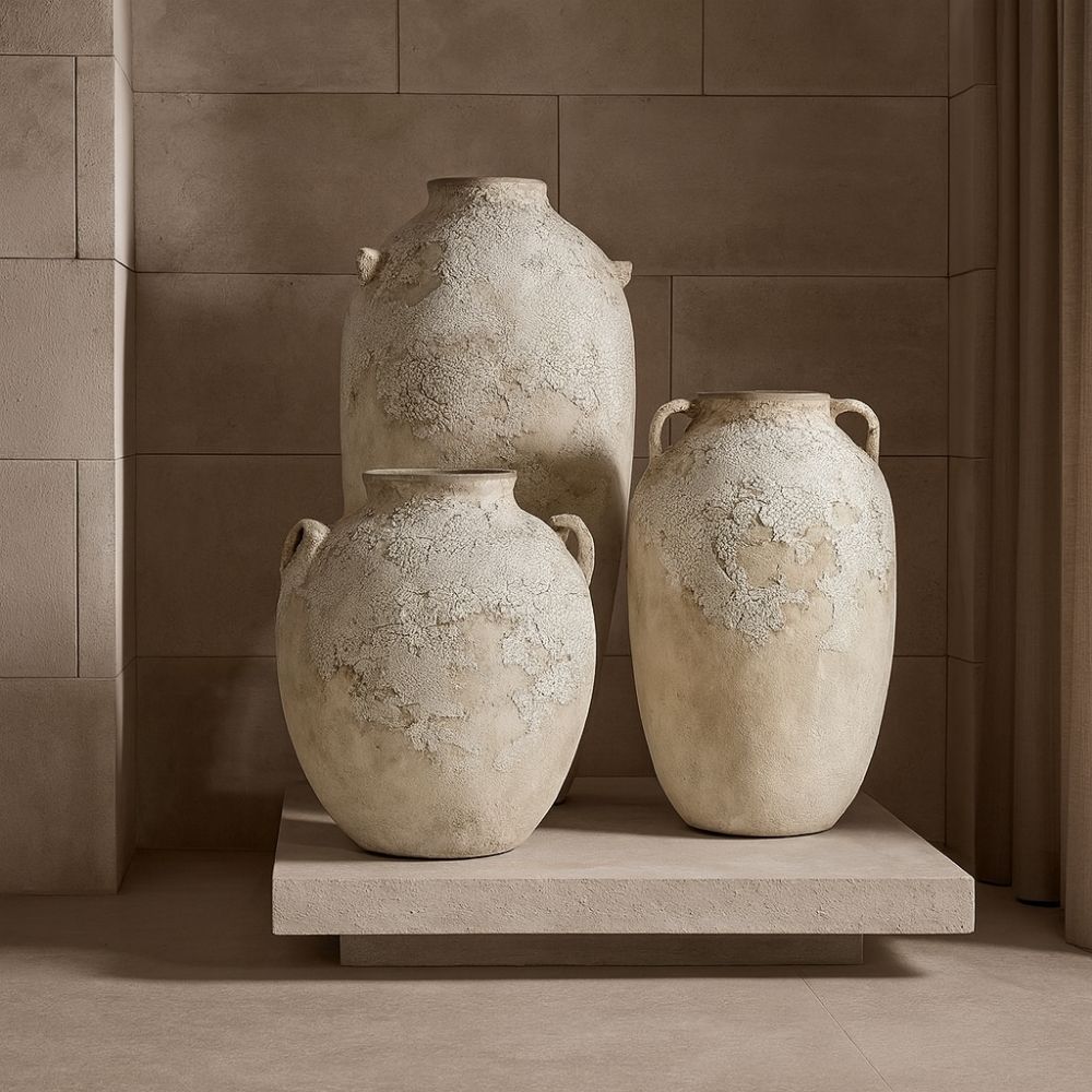 Set of three large handcrafted vases with a distressed, textured white finish and classic Mediterranean-inspired shapes.