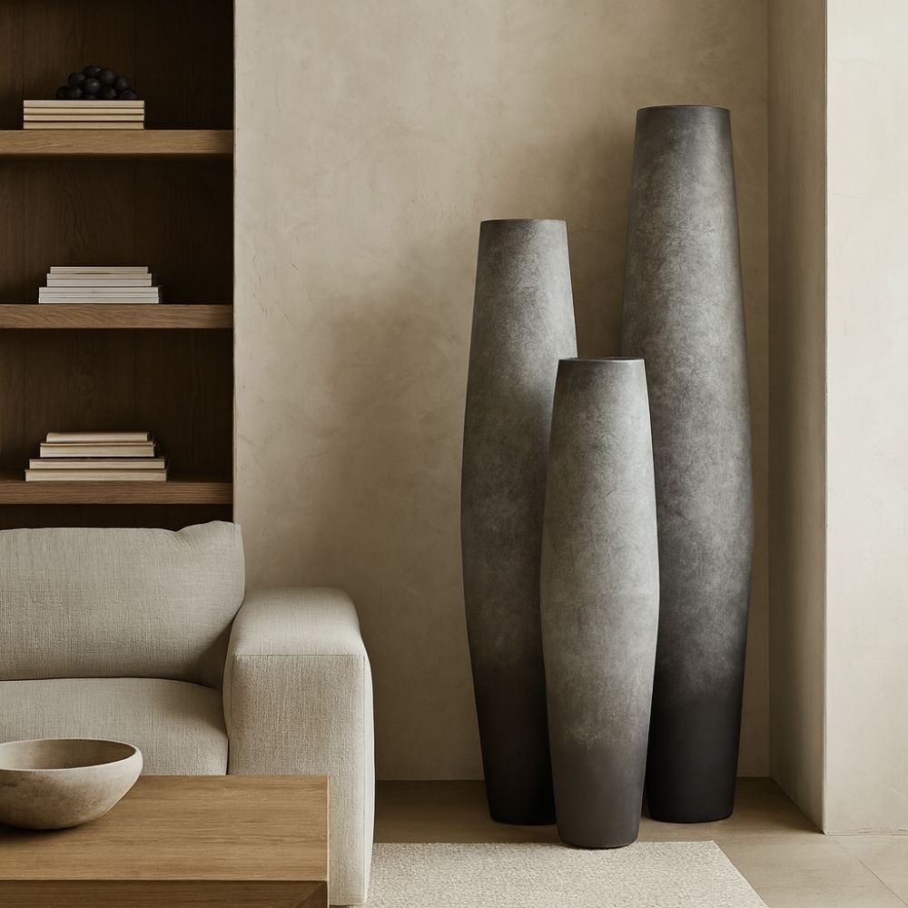 Set of three tall grey sculptural vases with ombré finish and elongated silhouettes.