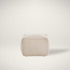 Square pouf in soft beige fabric with a casual, structured design.