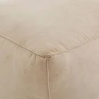 Square pouf in soft beige fabric with a casual, structured design.