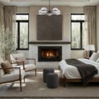 Round black pouf with sleek fabric upholstery.