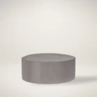 Universal Kirkos round ottoman in soft grey fabric upholstery