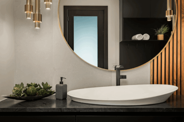Modern bathroom vanity with round mirror, vessel sink and wood slat accent wall designed by Urbanhome Interior Design in the Modern Manor on Lake St Clair