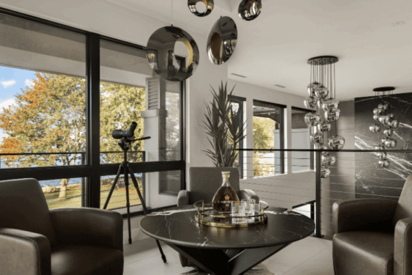 Contemporary upstairs lounge with marble coffee table and lake views in the Modern Manor designed by Urbanhome Interior Design