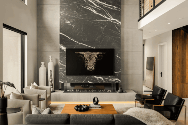 Double-height marble fireplace feature wall in contemporary luxury home designed by Urbanhome Interior Design in Windsor Ontario