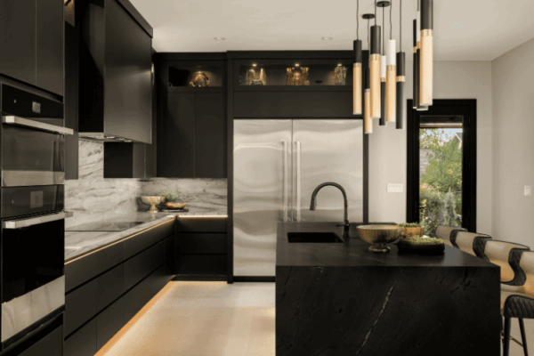 Contemporary black kitchen with large stone island and pendant lighting designed by Urbanhome Interior Design