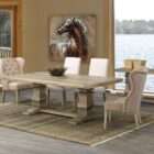 Rectangular wood dining table with a thick top, carved pedestal legs, and a horizontal stretcher base in a soft grey-brown finish.