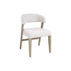 Upholstered dining chair with a curved wraparound back, light neutral fabric, and solid wood legs in a warm brown finish.