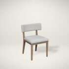 Upholstered dining chair in a soft light grey fabric with a solid wood frame and clean, tapered legs in a natural finish.