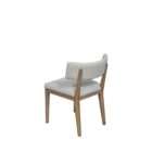 Upholstered dining chair in a soft light grey fabric with a solid wood frame and clean, tapered legs in a natural finish.