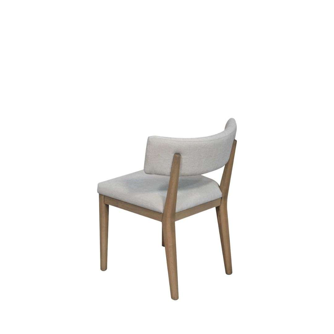 Upholstered dining chair in a soft light grey fabric with a solid wood frame and clean, tapered legs in a natural finish.