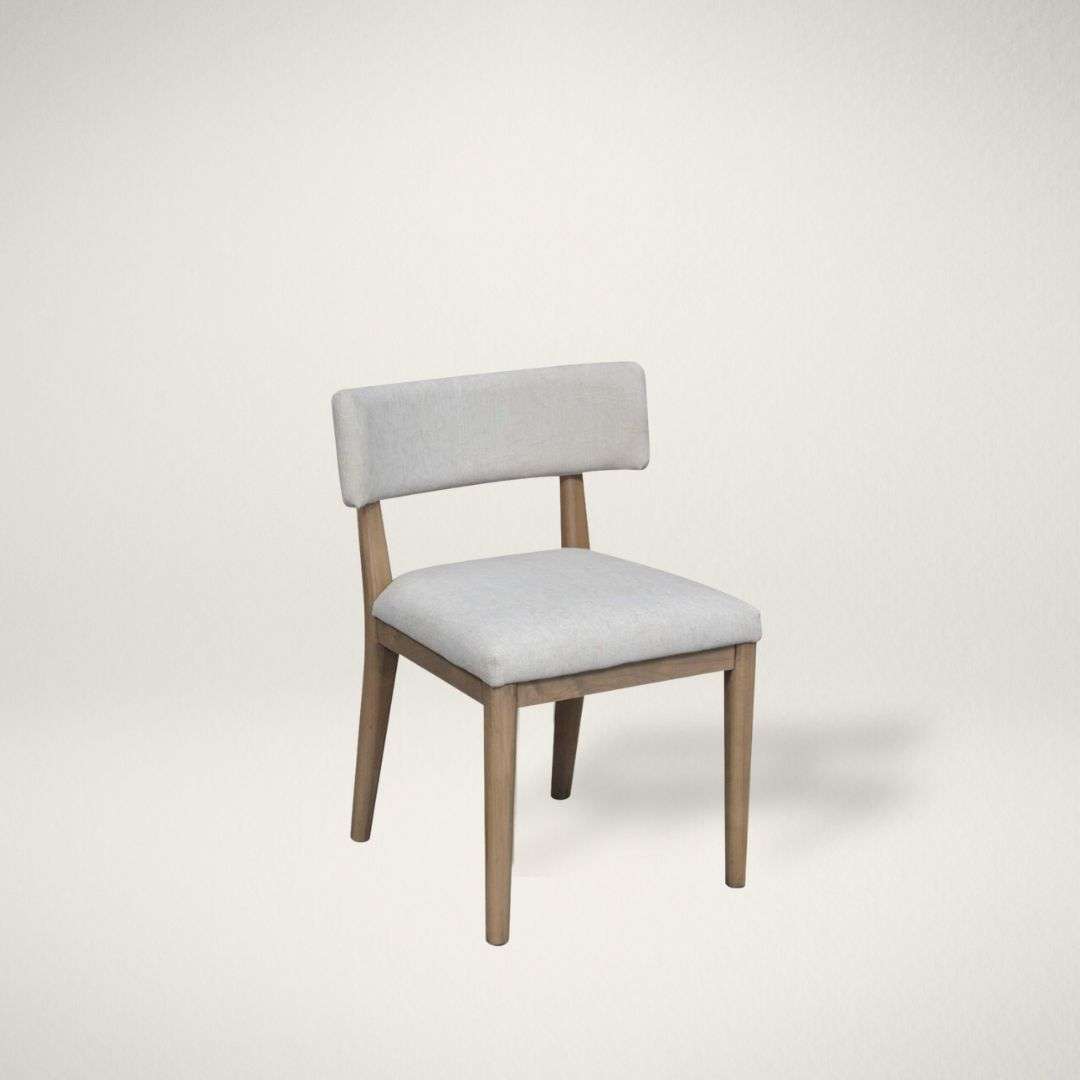 CW FREYA Upholstered dining chair in a soft light grey fabric with a solid wood frame and clean, tapered legs in a natural finish.