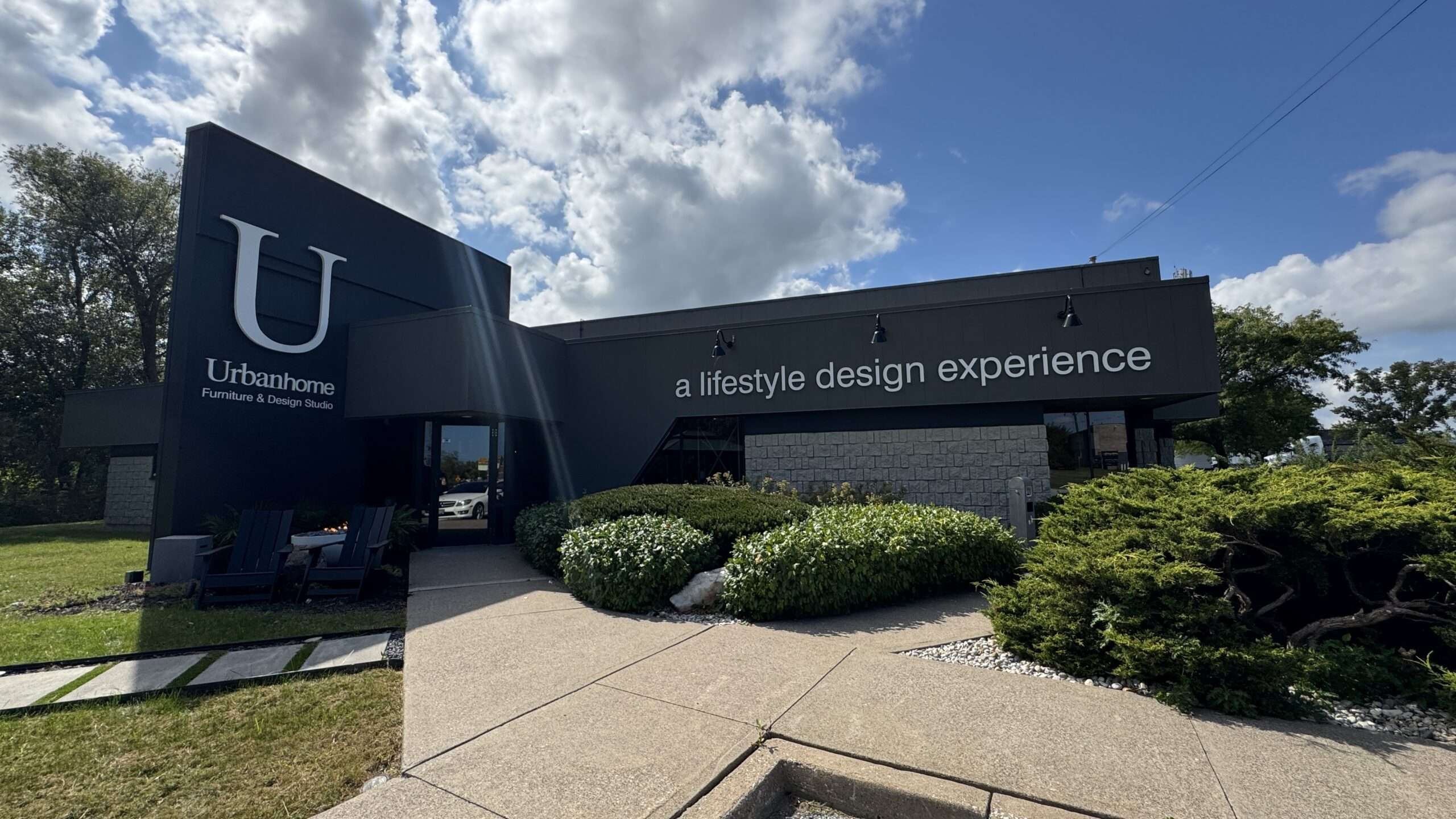 Curated furniture showroom in Windsor Ontario with designer sofas, lighting, rugs, artwork, and home decor