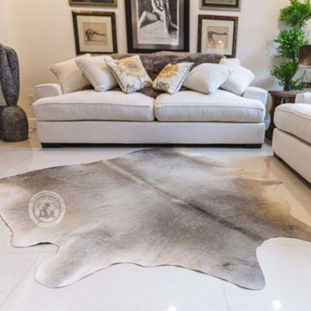 Luxury grey cowhide rug with natural organic shape and soft tonal variations in grey and taupe