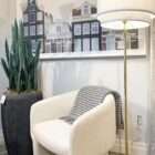 Artificial snake plant in a black pot featuring tall, upright green leaves with variegated striping.