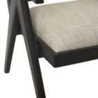 Modern black wood accent chair with woven cane back and neutral upholstered seat.