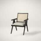 Modern black wood accent chair with woven cane back and neutral upholstered seat.