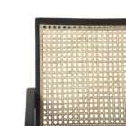 Modern black wood accent chair with woven cane back and neutral upholstered seat.
