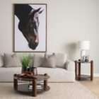 Round coffee table with a natural marble top in warm brown and cream veining, supported by sculptural wood legs and a matching lower shelf.