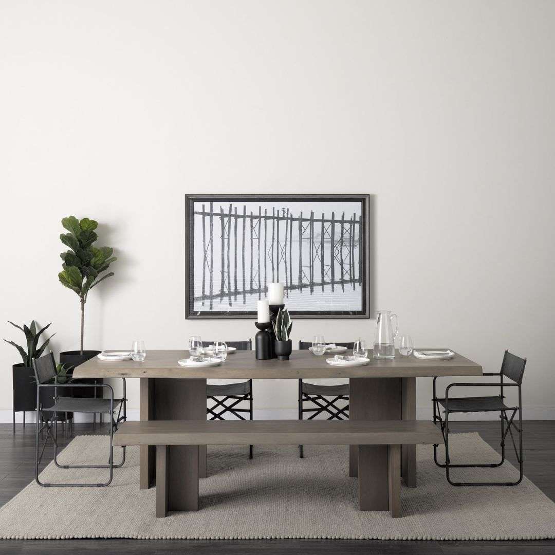 Rectangular wood dining table with a natural live-edge inspired top and solid panel base legs in a warm medium wood finish.