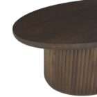 Round wood coffee table with a smooth top and a fluted cylindrical base in a warm medium wood finish.