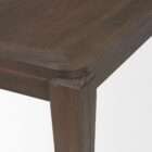 Rectangular wood dining table with a clean top and tapered legs in a warm medium-dark finish.
