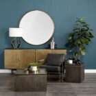 Modern black leather accent chair with sleek brass metal frame and minimalist silhouette.