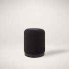 Renwil Castillo ottoman in dark textured upholstery with cylindrical shape and black base