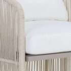 Outdoor lounge chair with woven rope sides in a soft neutral tone, featuring a light frame and plush white seat and back cushions.