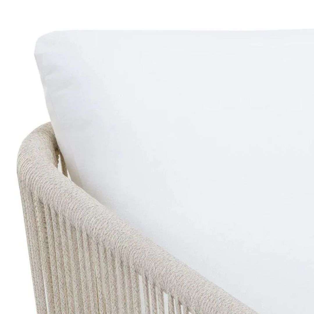 Outdoor lounge chair with woven rope sides in a soft neutral tone, featuring a light frame and plush white seat and back cushions.