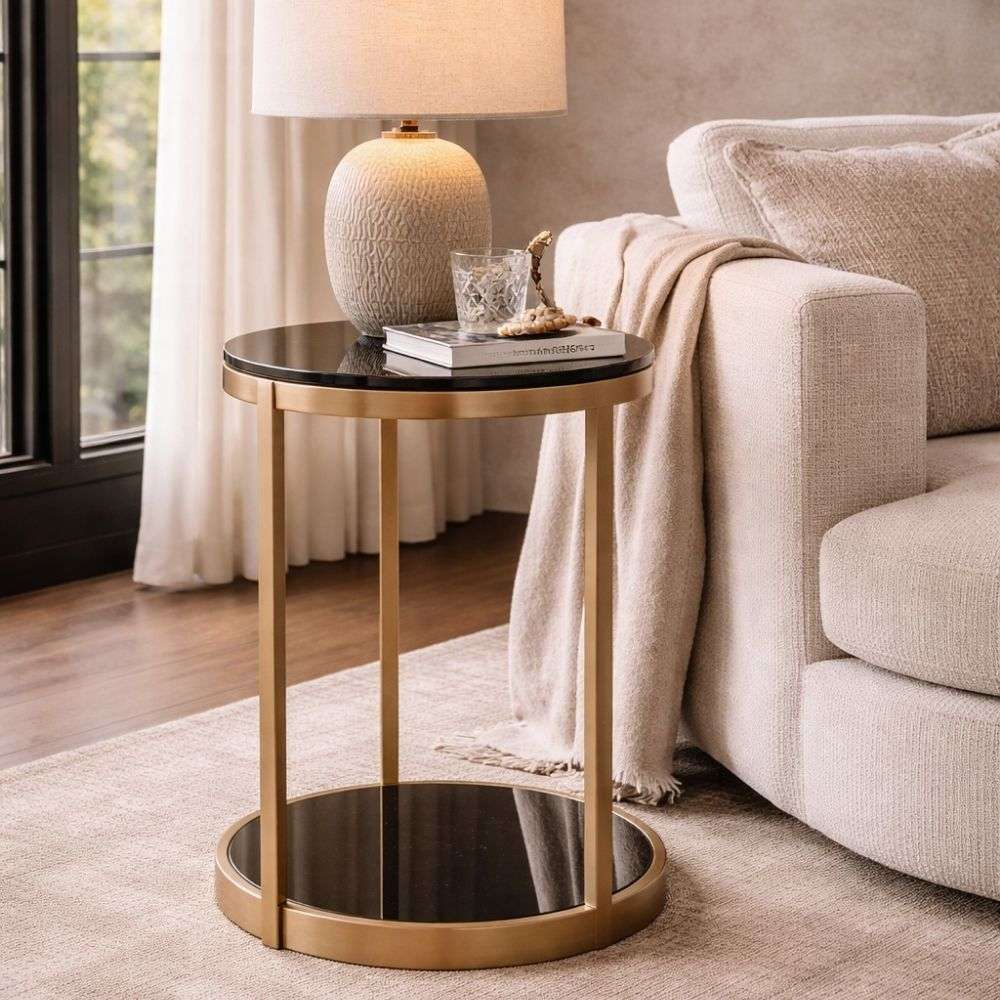 Round side table with black glass top and base, supported by a slim gold metal frame.