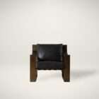 Modern lounge chair with a bold architectural wood frame in a warm brown finish, featuring a black leather seat and back cushion.