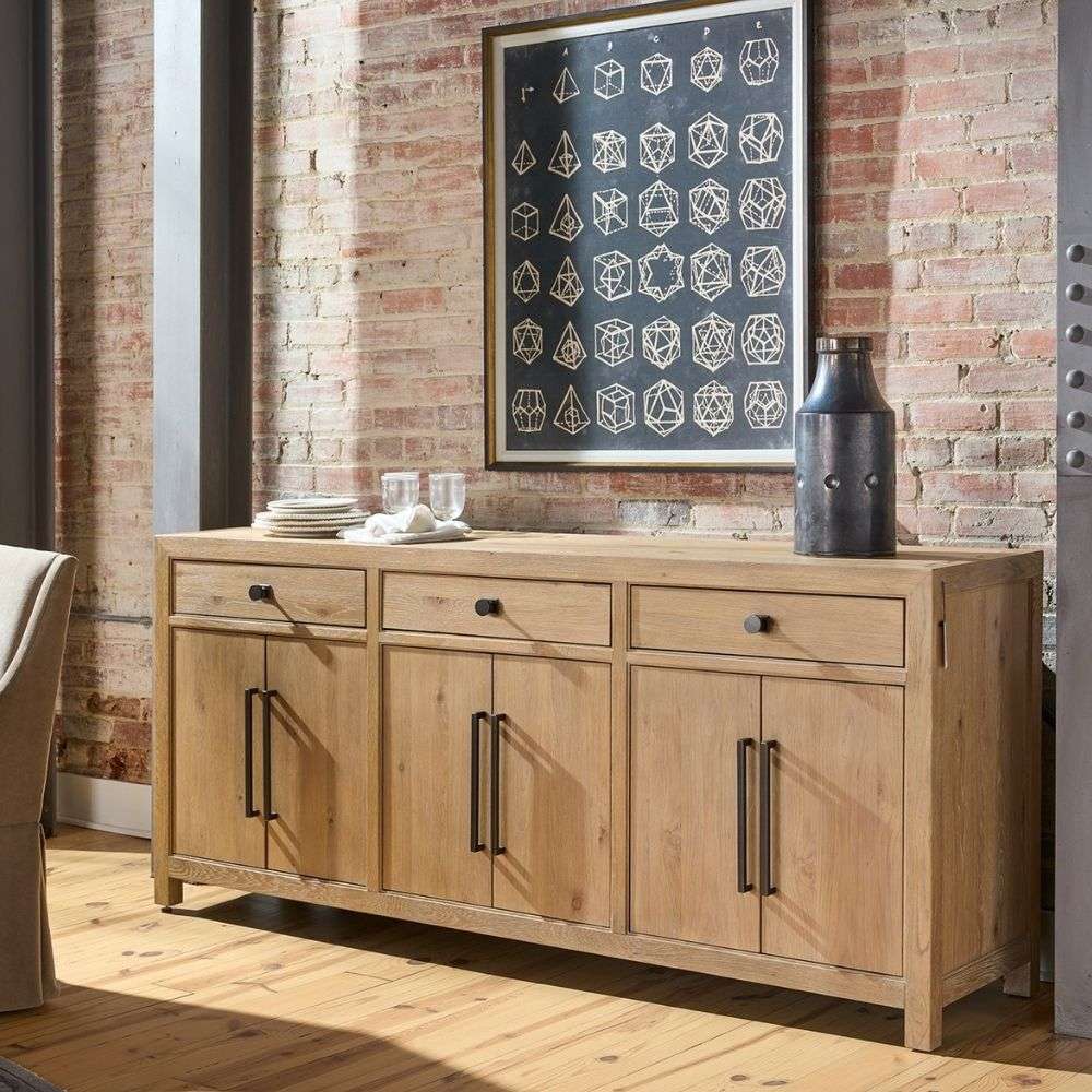 Light wood credenza with three drawers and six cabinet doors, featuring black metal hardware.
