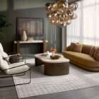 Modern chandelier with brass frame and clustered smoked glass globe shades creating a sculptural lighting fixture.